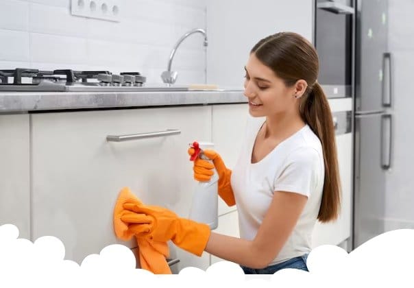 cleaning lady wiping face of cabinet